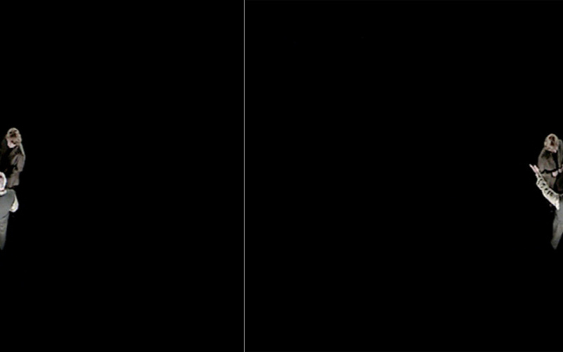 Black background: View from above of a man and a woman in conversation