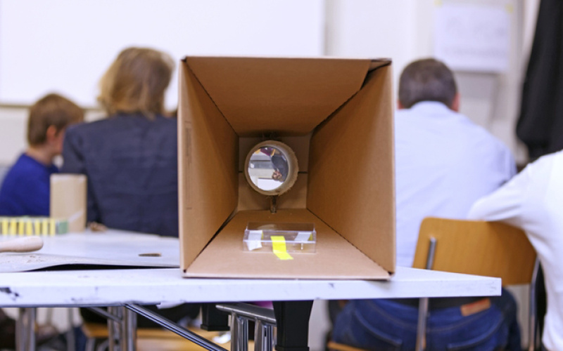 selfmade projector out of cardboard is lying on a table