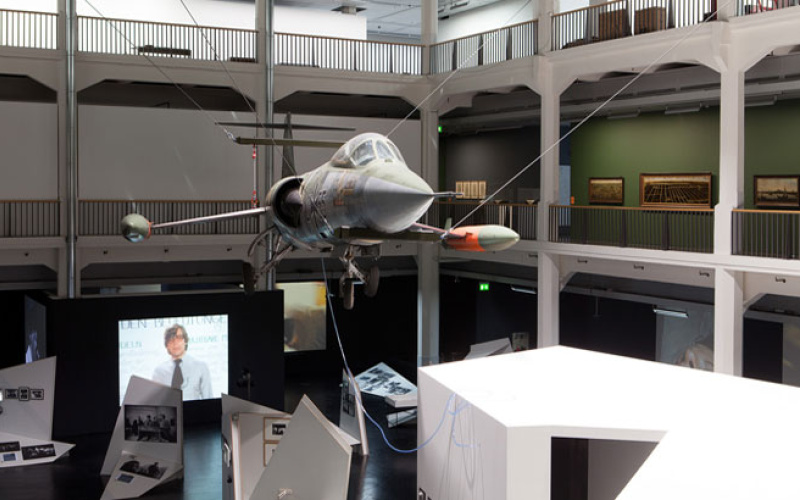 Airplane is hanging on cables in an atrium