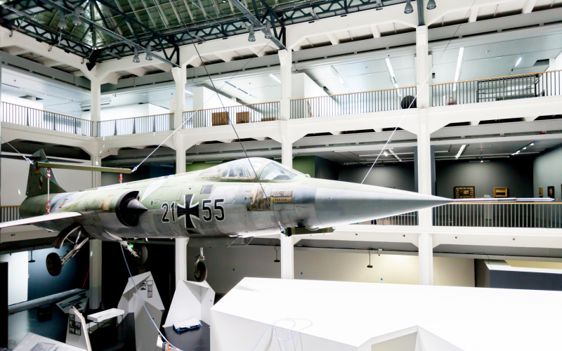 A starfighter which is hanging from the ceiling in the museum