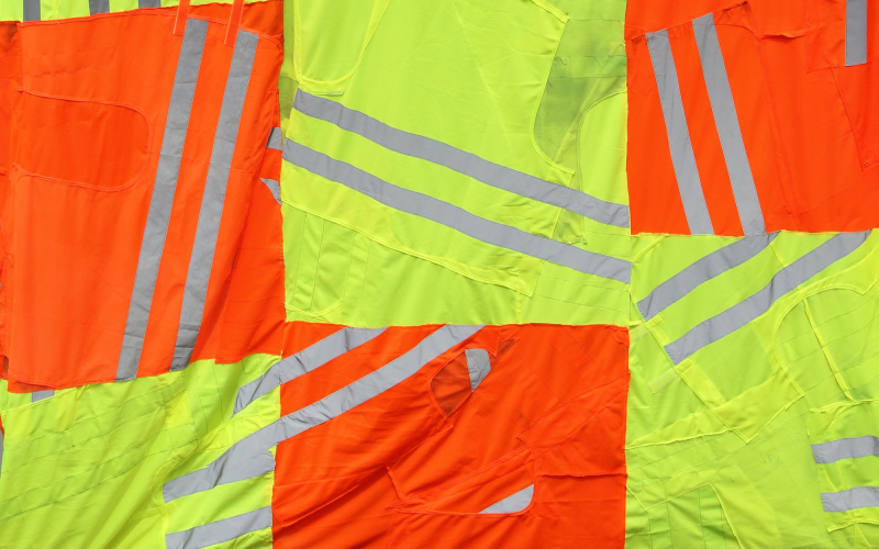 Yellow and orange safety vests fabric tied together to a three times 4 large area