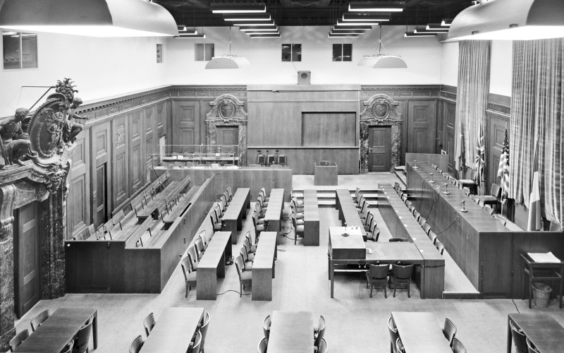 Black and white photograph from 1945, showing the empty room 600 of the Nuremberg Palace of Justice.