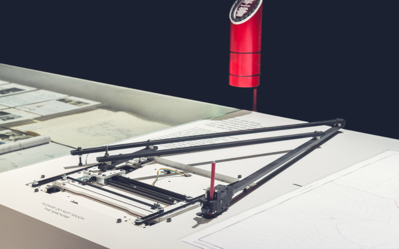 A machine on a table drawing records.