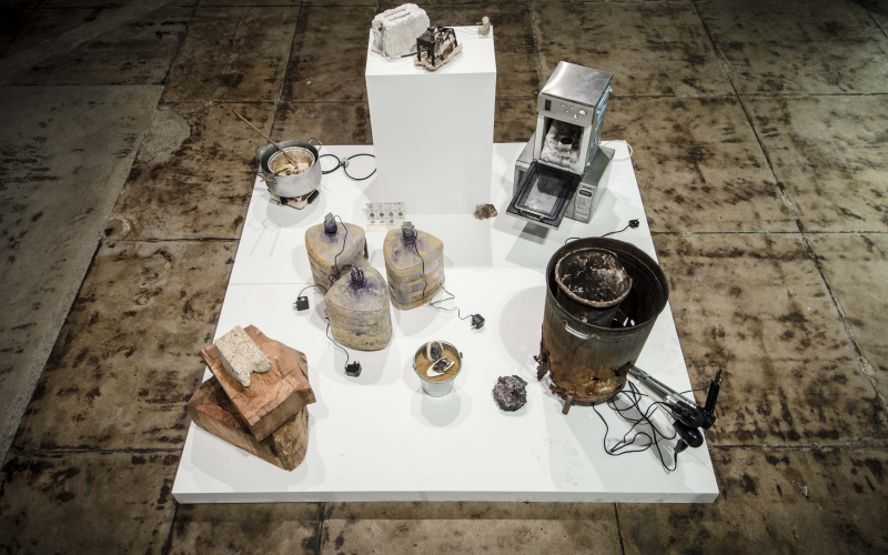 Stones and buckets on a white podium