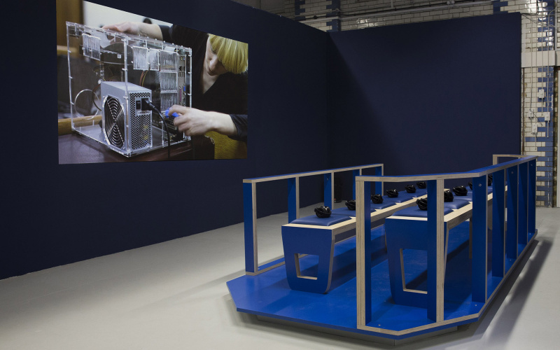 Video installation in front of blue seating.