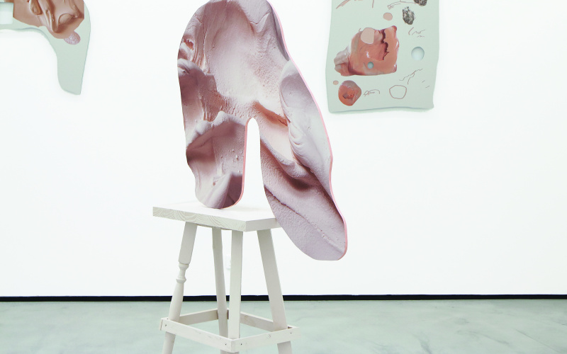a pink organic sculture on a chair