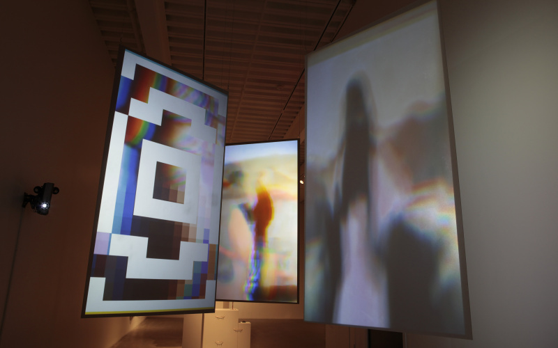 Three installations hanging in a line