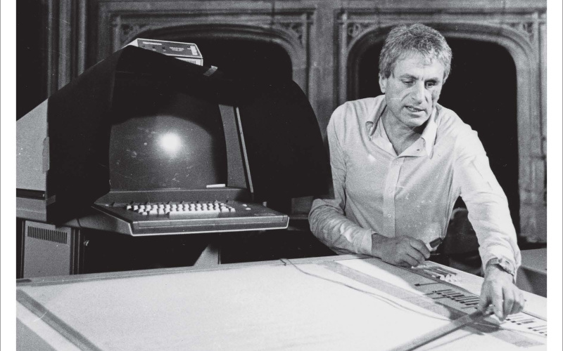 Publication cover: UPIC. Orange font and a black and white photograph showing a man working on a computer program that digitally translates graphic notation into sound.