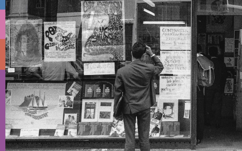 A man is standing in front of the window of the Better Books bookstore.