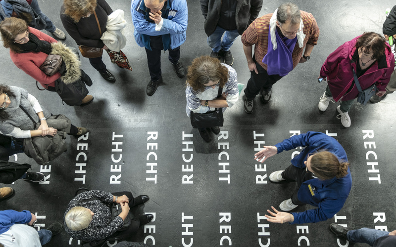 Many people photographed from above during a tour of the exhibition »respektive Peter Weibel« at ZKM.