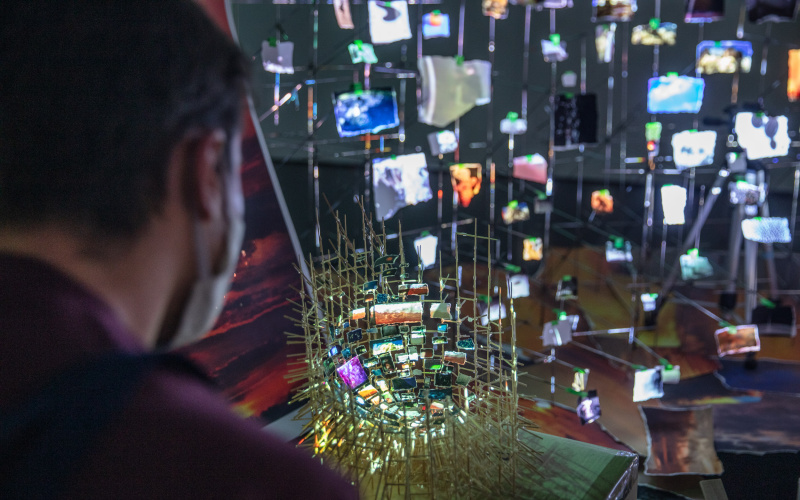 The photo shows a close-up of Sarah Sze's artistic work called "Flash Point". It is an incredibly detailed flood of images, built on a fragile nest-like scaffolding.
