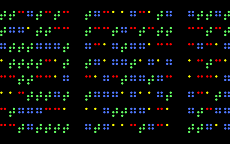 Arrangement of different coloured dots on a black background