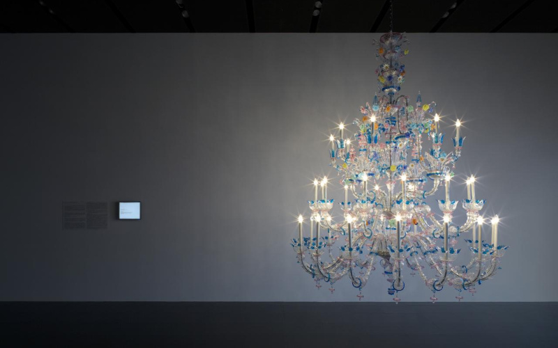 Colourful chandelier in front of a grey wall