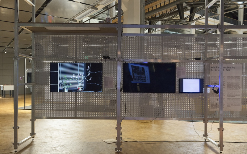 The picture shows three screens attached to a grid structure