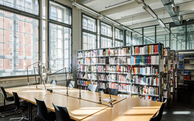 The ZKM Library with desks. In the background bookshelves