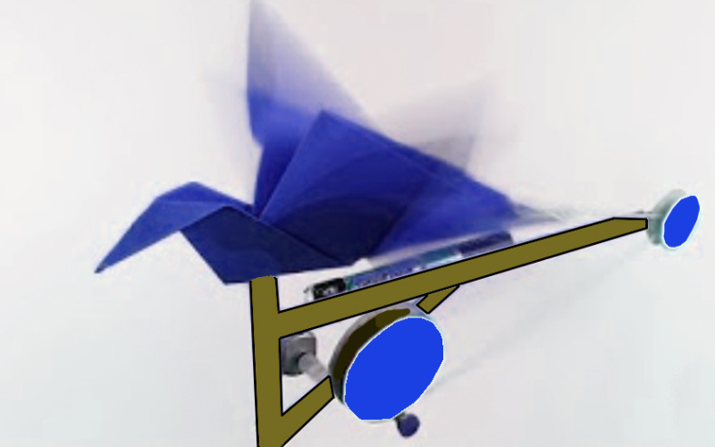 A origami-bird out of blue paper is sitting on a construction with wheels. Also there is a battery attached to the object.