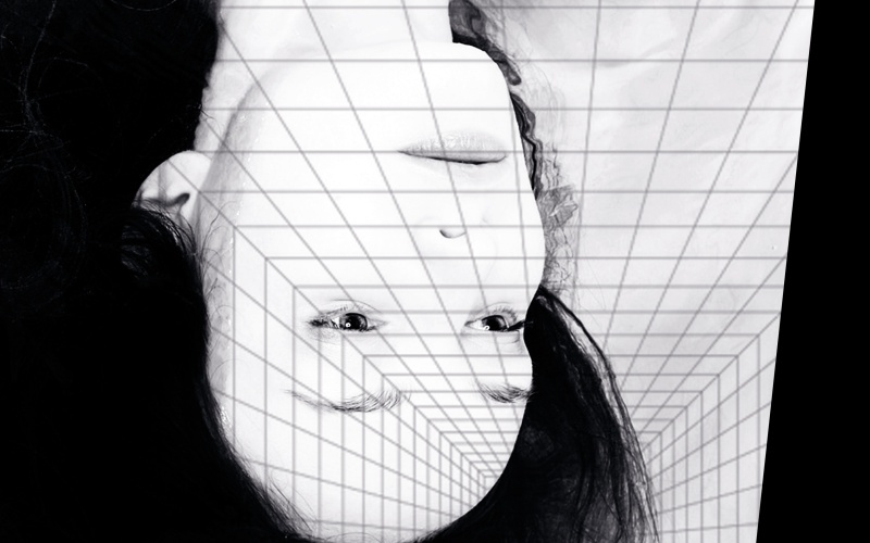 The head and neck of a woman can be seen upside down, she has long hair and an expressionless lead. The background resembles computer-generated tiles, which also cover her face.