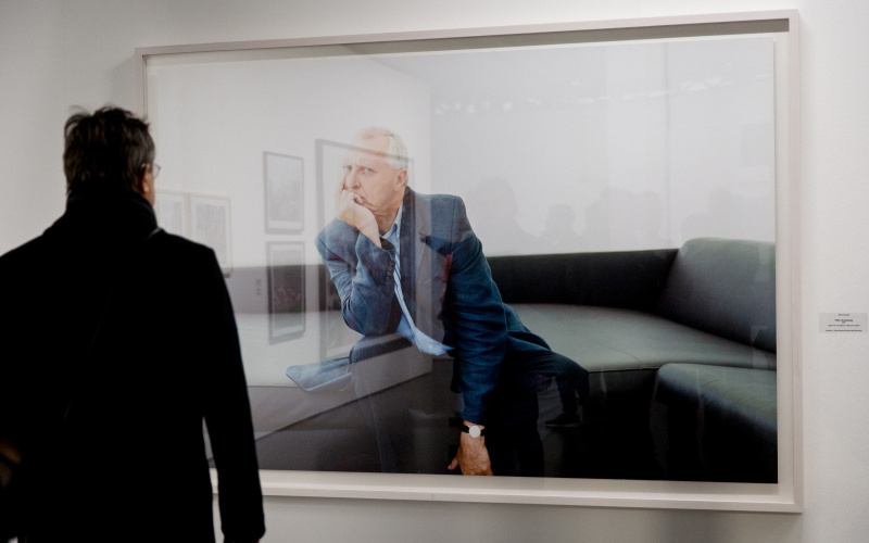 A man is standing in front of a great photograph