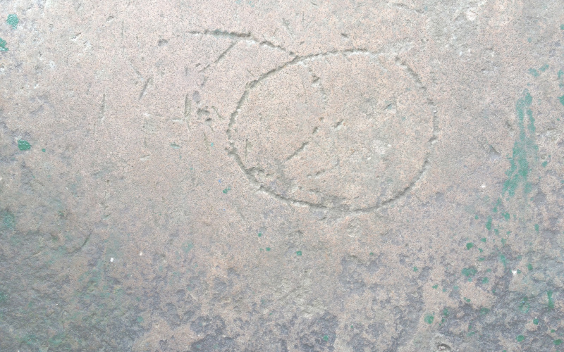 Circular shapes carved on a stone surface.