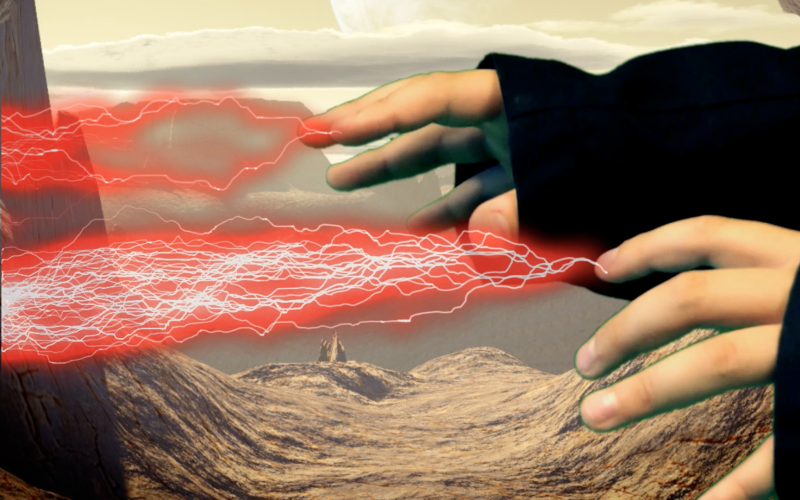 Standbild aus einem Film - Aus den Fingern eines Kindes scheinen rote Blitze zu kommen, ein Effekt, der mit einem Filmbearbeitungsprogramm hinzugefügt wurde.