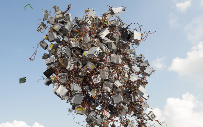 The picture shows an animated pile of electronic devices rising into the sky.