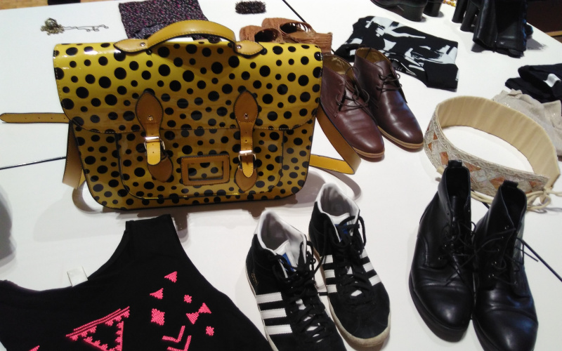 You can see a yellow dotted bag surrounded by shoes and a t-shirt.