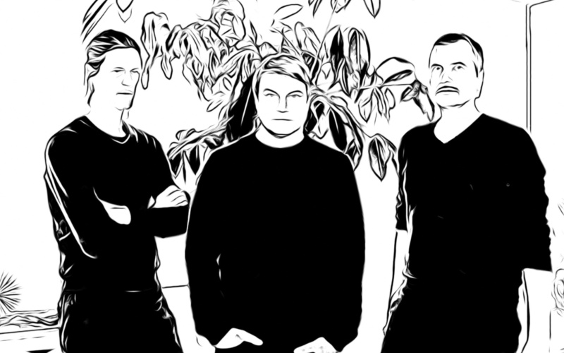 Das Bild ist in schwarz weiß gehalten und erinnert an eine Skizze. Es zeigt drei Männer vor einer Pflanze.