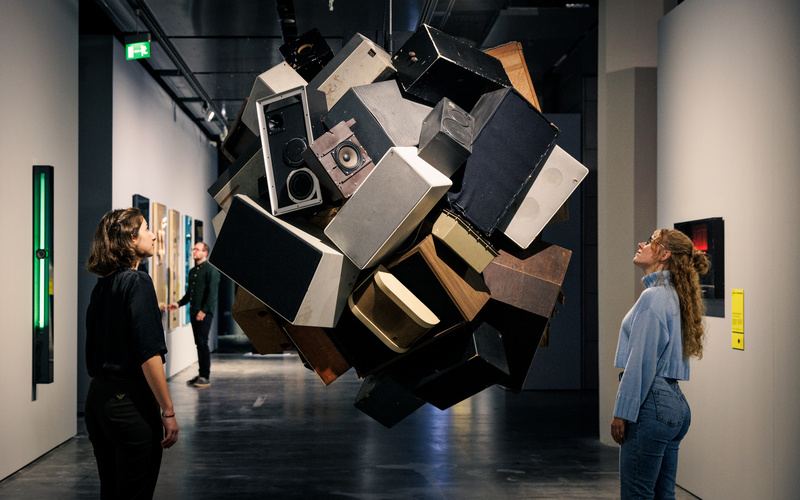 Visitors look at art.