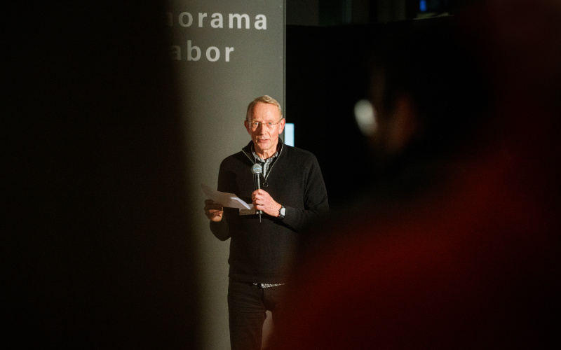 A person with a microphone is seen at the opening of the exhibition »Repairing the Present :RETOOL« 