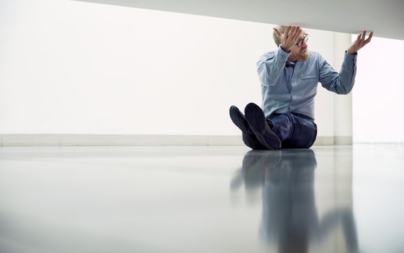 You can see William Forsythe sitting on a floor. With his hands he touches a floating platform.