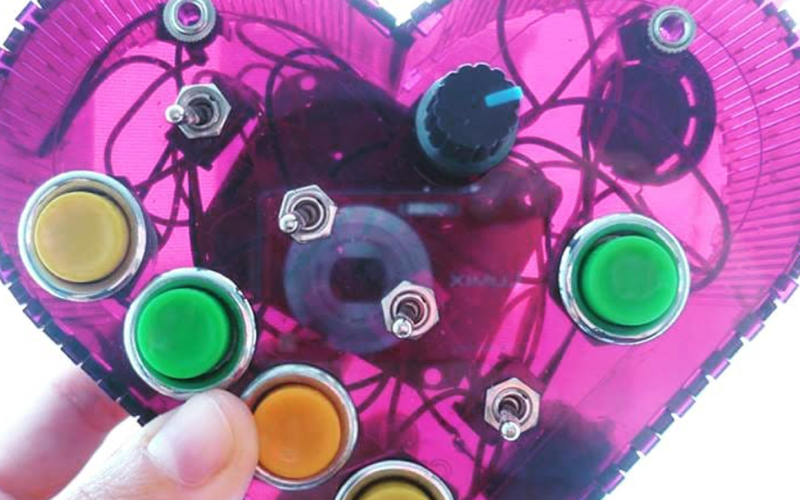 Photo of pink heart with wires and buttons