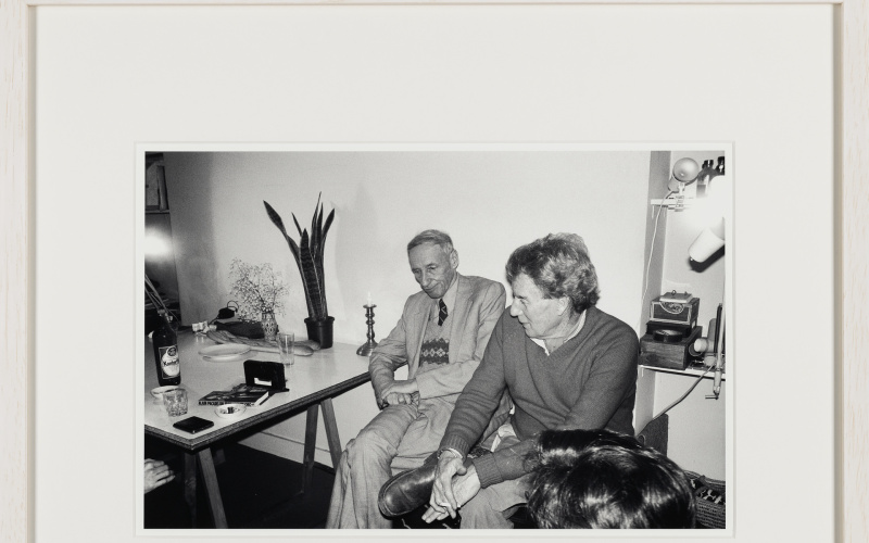 Enjoying a visit by William Burroughs. The two best friends sitting on Brion’s Tanger chest, holding important documents of the two. The shock of hair in the foreground could be Terry Wilson’s who often came over from London whenever WSB was visiting