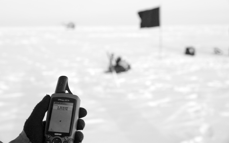 The picture shows a black flag at the North Pole in black and white.