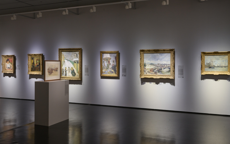 Illuminated pictures hanging in a dark room