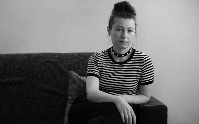 A woman with a bun and striped T-shirt