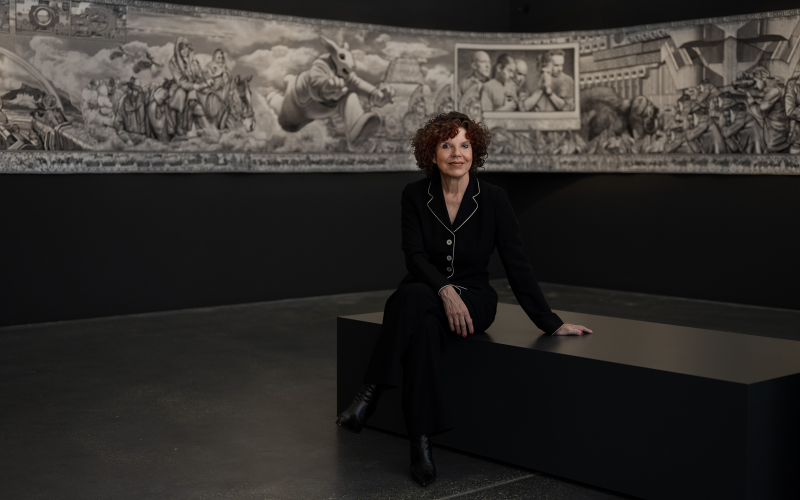 The artist Margret Eicher in front of one of her tapestries