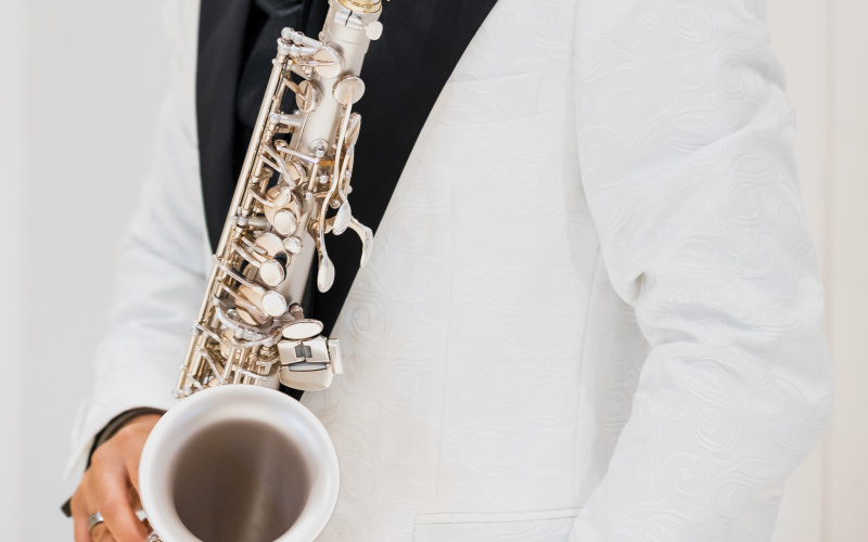 You see a person in a white suit with a musical instrument. 