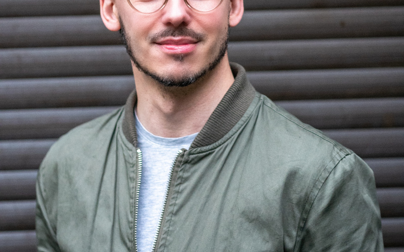 You can see a person with brown hair and glasses. 