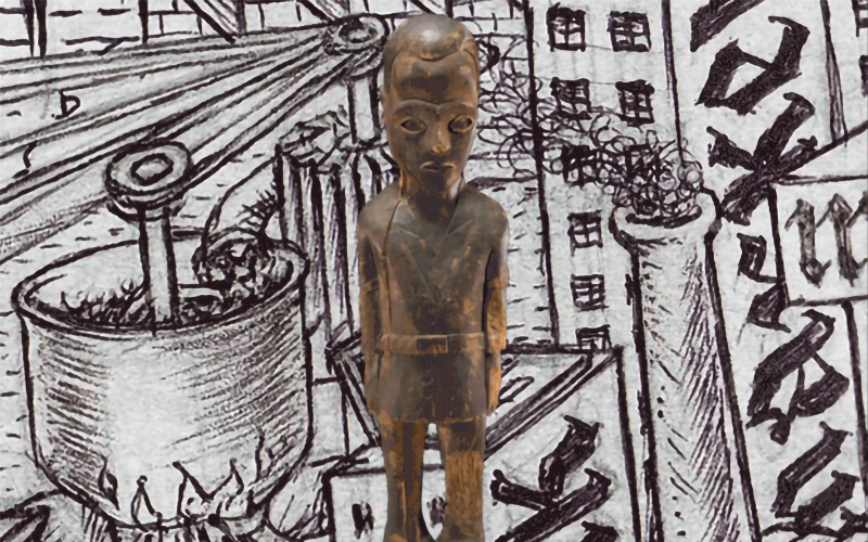 A wooden figure against a background with drawings