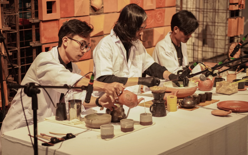 Several people can be seen performing a tea ceremony.