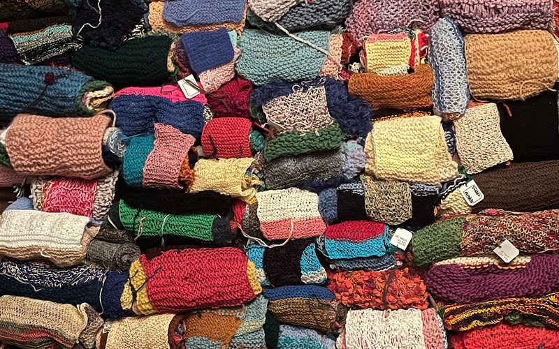 You can see various scarves stacked on top of each other.