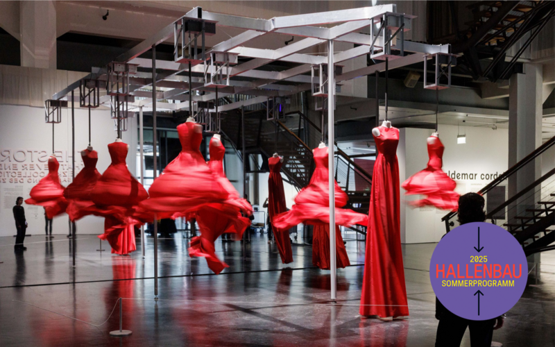 Red, spinning dresses are displayed in an exhibition.