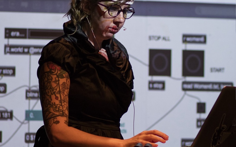 A person can be seen on a stage. 