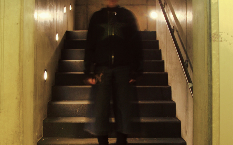 A person standing on a staircase can be seen. 