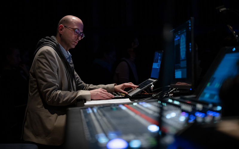 Bald man (Peter Gahn) standing in front of a mixing desk.