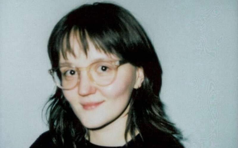 Women with black hair and glasses (Denisa Pubalova) smiling at the camera