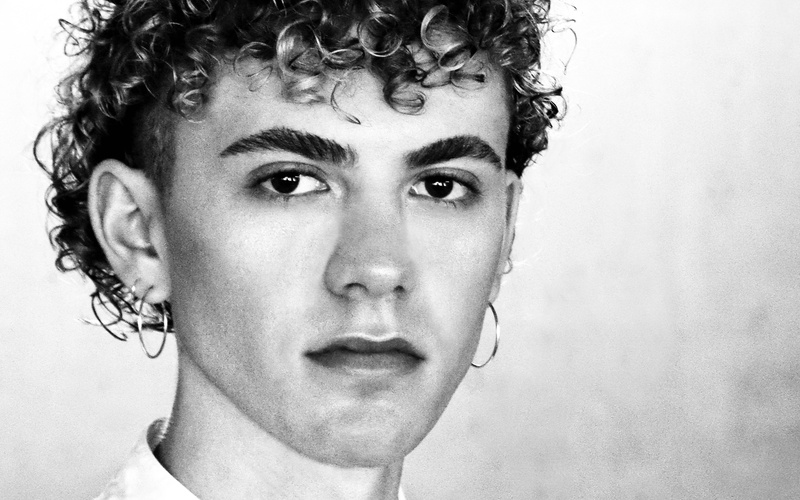 A black-and-white portrait of a person can be seen.