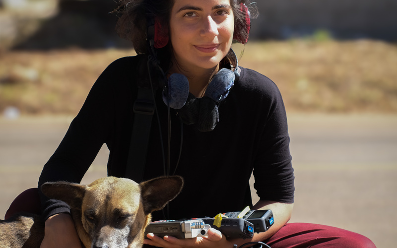 The portrait photograph shows a person with a dog. 