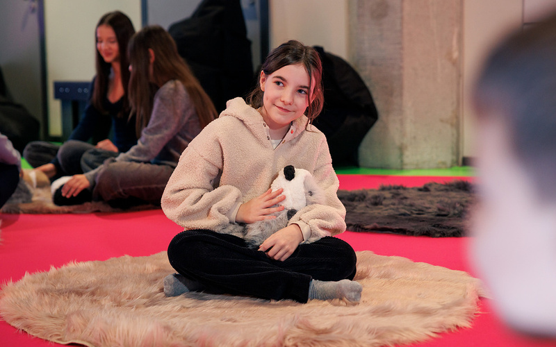 A girl with a Booboo robot guinea pig.