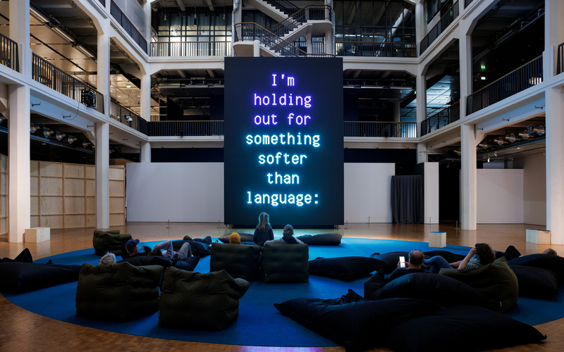 The image shows a huge screen displaying text.  